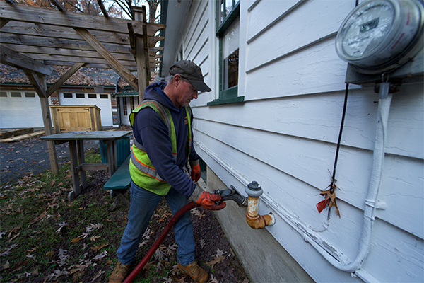 Domino Fuel driver filling a residential heating oil tank on Long Island